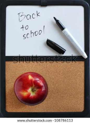 Back to School written on marker board and apple on a board