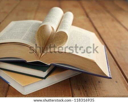 Opened book. Pages of the book folded into a heart shape