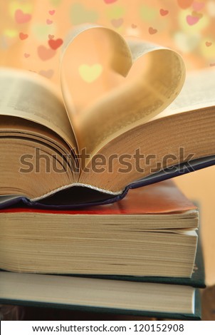 Opened book. Pages of the book folded into a heart shape
