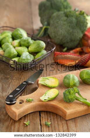 Brussels sprouts and broccoli on wooden table