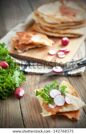 Homemade milk flat bread with cream cheese, lettuce and radish