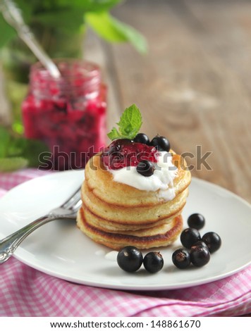 Pancake with sour cream and black currant jam