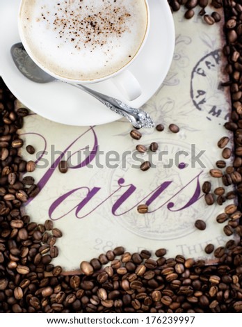 Cup of coffee and coffee beans. Small depth of field.