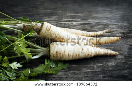 Fresh parsley root on wooden background. Toned image