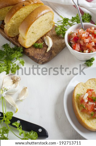 Garlic bread  topped with tomato, garlic and herbs