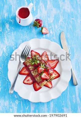 Crepes with fresh strawberry and strawberry sauce.