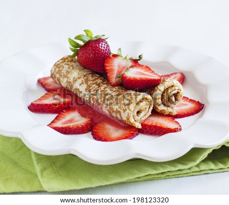 Crepes with fresh strawberry and strawberry sauce.