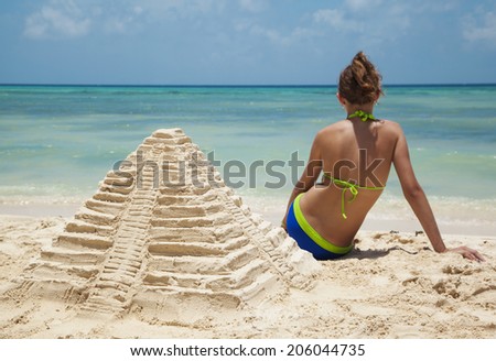 Sand Castle on Beach. Mayan pyramid from sand. Selective focus on sand castle