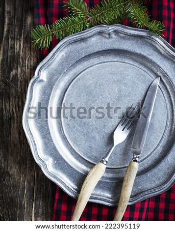 Vintage silverware on rustic metal plate for Christmas Dinner.