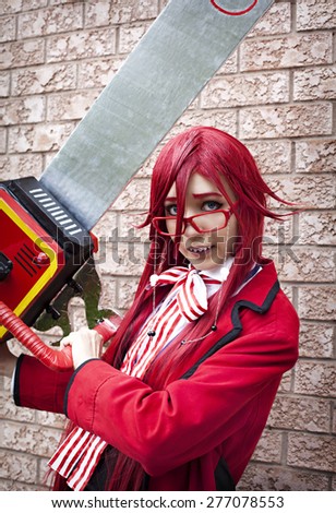 TORONTO - MAY, 23 : Caucasian girl wearing Grell Sutcliff Cosplay Japanese anime character cosplay pose at Anime Convention in Toronto, May 23,  2014