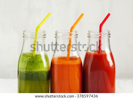 Fruits and vegetable juice in bottle: Apple and spinach juice, Carrot juice and Tomato juice