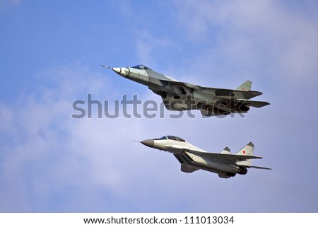 ZHUKOVSKY - AUGUST 12: New Russian five generation\'s fighter T-50 and mig-29 show demonstration flight at show dedicated to the centenary of the Russian Air Force August 12, 2012 in Zhukovsky, Russia.