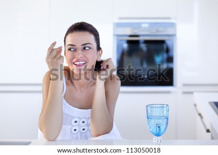 Portrait of beautiful relaxed young woman thinking in the her kitchen
