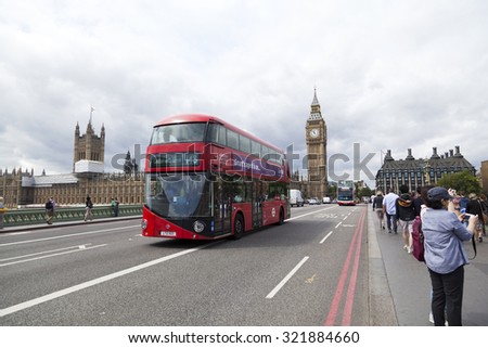 LONDON - 2015 AUGUST 5 : There is tourism traffic everyday in London.  Thousands cars, taxis, buses and pedestrians crossing River Thames on historic Westminster Bridge.