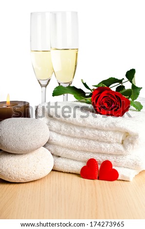 Romantic spa decoration with candles, spa stones and champagne