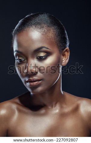 Beauty portrait of handsome ethnic african girl, on dark background