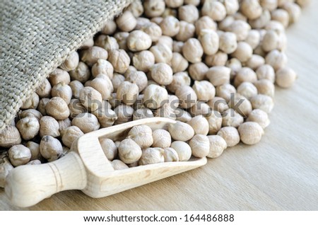 Chickpeas in a wooden spoon and bag