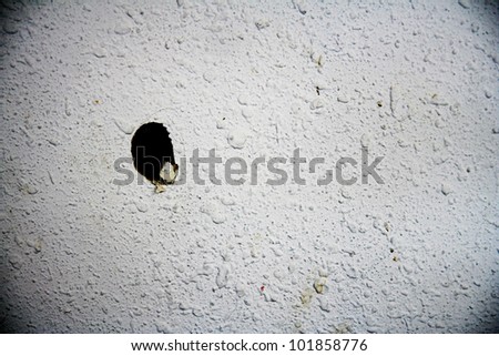 image from wood texture background series (plaster wall with a hole punched through)
