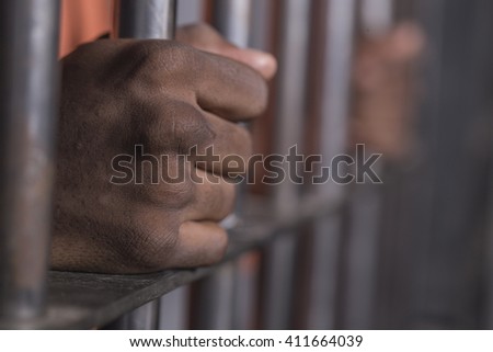 People In Jail - African american man behind bars
