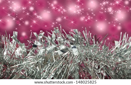 Silver tinsel with pink sparkle background