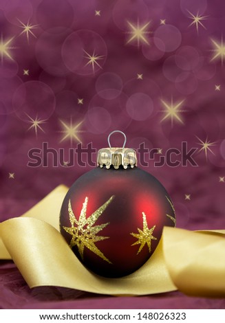 Red and gold christmas bauble with gold ribbon