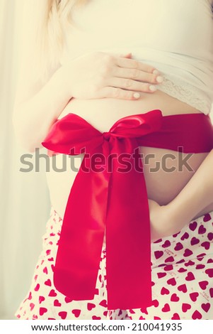 The pregnant woman with a red tape
