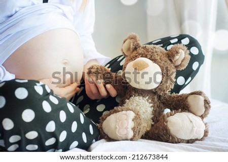 Pregnant Woman Holding Teddy Bear
