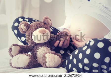 Pregnant Woman Holding Teddy Bear