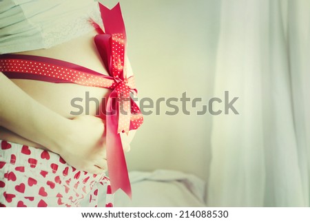 The pregnant woman with a red tape