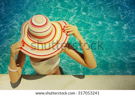 Beautiful young woman relaxing in the swimming pool