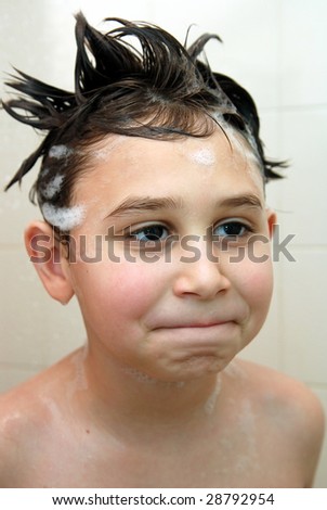 Monkey face.Young boy  having fun under the shower.Seven-eight year old