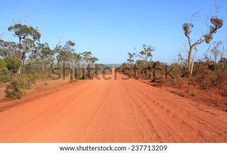 A straight section of red dirt outback road on the Cape York Peninsula with corrugation.