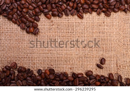 Roasted coffee bean border on a burlap sack background