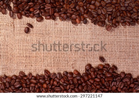 Roasted coffee bean borders with copy space on a burlap background