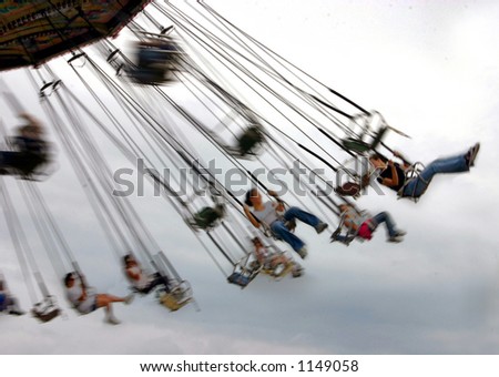 Swings at amusement park with motion blur to demonstrate the motion of the swings