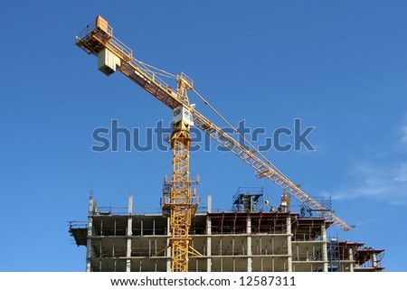 Construction Crane and a modern building with concrete columns and floors