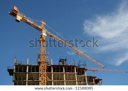 Construction Cranes and a modern building with concrete columns and floors