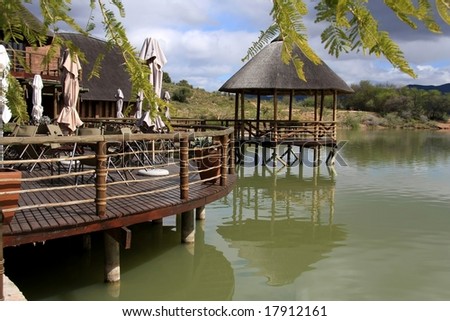 Rustic safari lodge at a holiday resort next to a dam