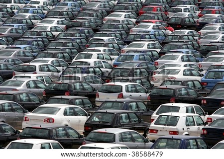 Brand new motor vehicles in a parking lot waiting for export