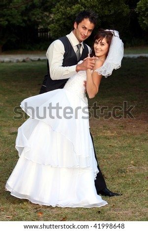 Beautiful wedding couple dancing on the lawn