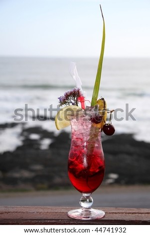 Tropical cocktail drink in a tall glass with lots of ice