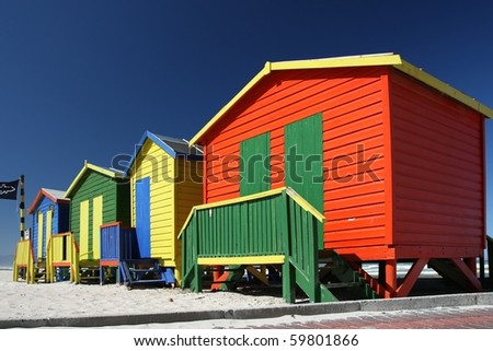 Brightly painted summer beach change rooms at the sea side in Cape Town