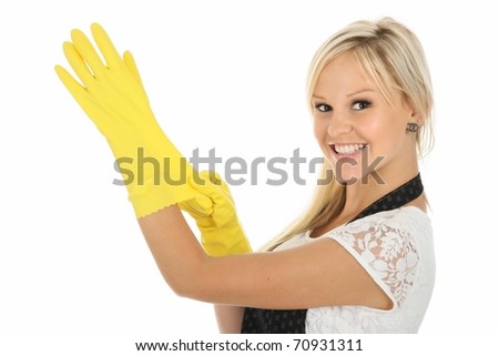 stock photo Beautiful blonde housewife putting on yellow latex cleaning 