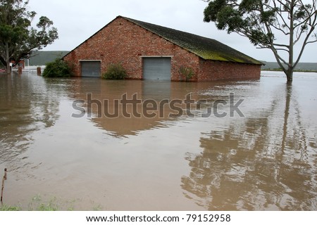 Flooded store room building with water half way up it\'s walls