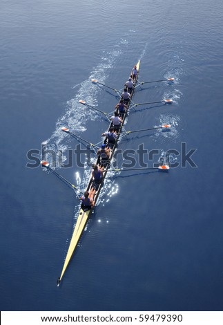 Eight men rowing