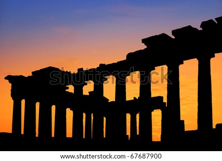 Silhouette of Parthenon Greek temple at sunset.