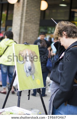 TORONTO, CANADA - 8 JUNE 2013 : A dog portraits is being made at woofstock, on  June 8, 2013 in Toronto, Ontario.