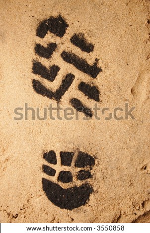A bootprint in sand to illustrate a carbon footprint