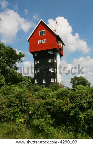 Tall house against blue sky and clouds