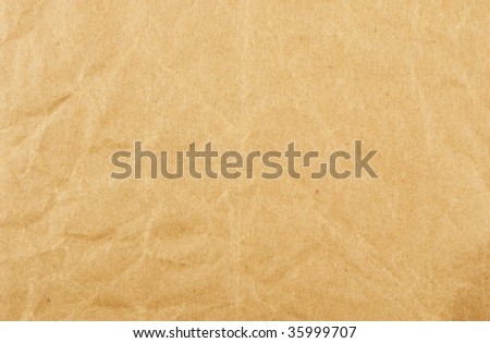 Old creased brown paper as a background and texture